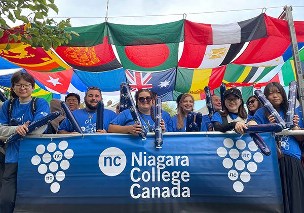 A group of English language students on a NC Wine Parade float